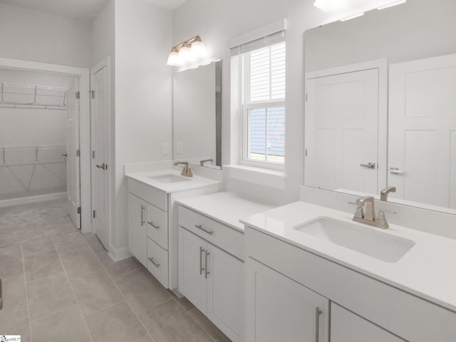 bathroom featuring tile patterned floors, vanity, and a healthy amount of sunlight