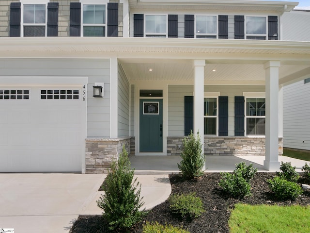 entrance to property with a porch and a garage