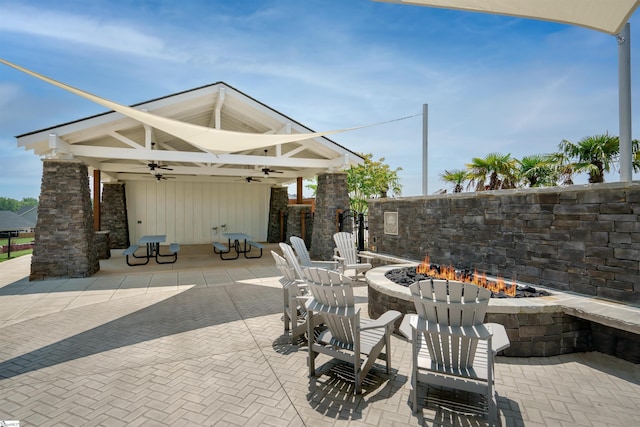 view of patio featuring a fire pit and ceiling fan