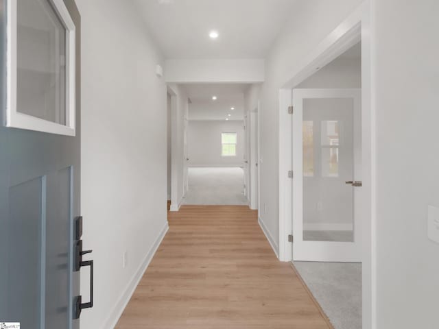 hallway featuring light carpet