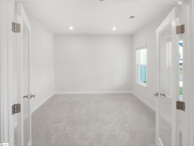 empty room with light colored carpet