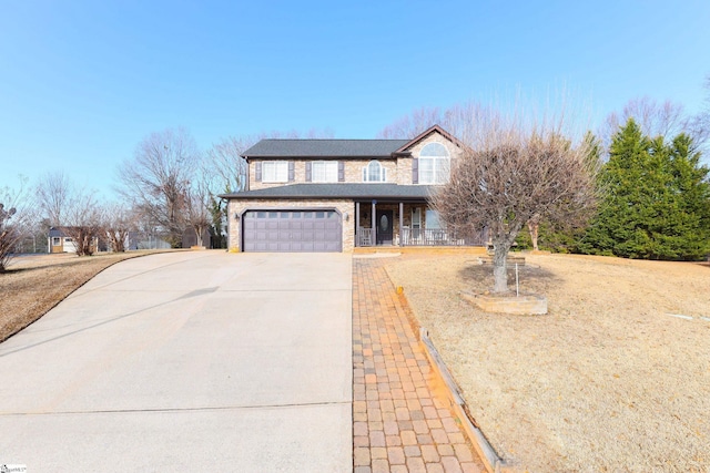 front of property featuring a porch and a garage