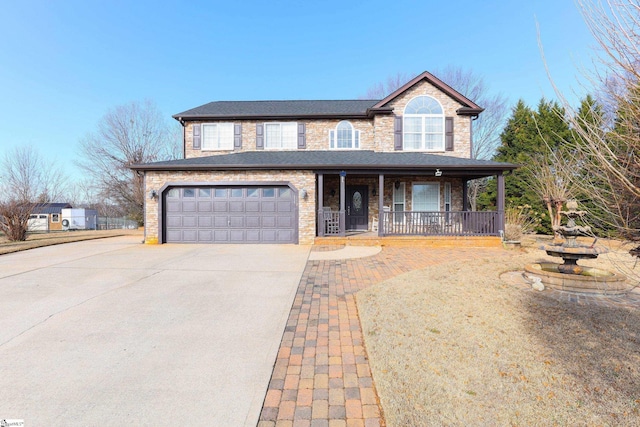 view of front of home featuring a porch and a garage