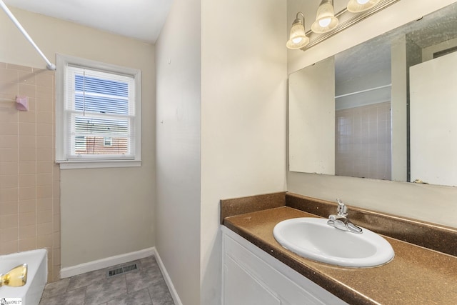 bathroom featuring tile patterned floors, vanity, and shower / bathing tub combination