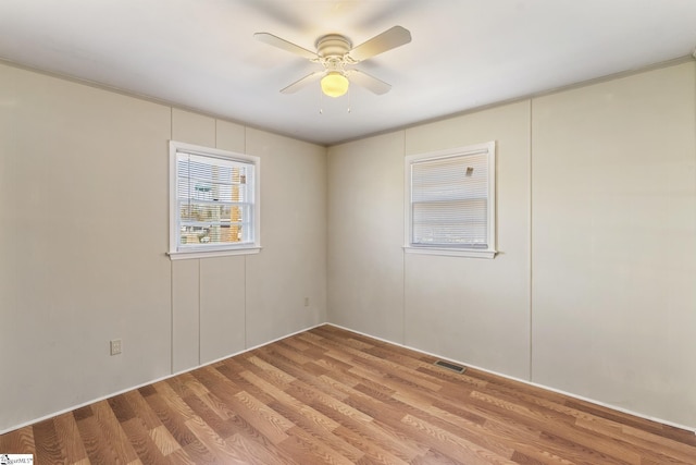 empty room featuring ceiling fan and light hardwood / wood-style flooring