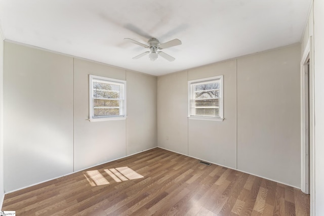 unfurnished room with ceiling fan and wood-type flooring