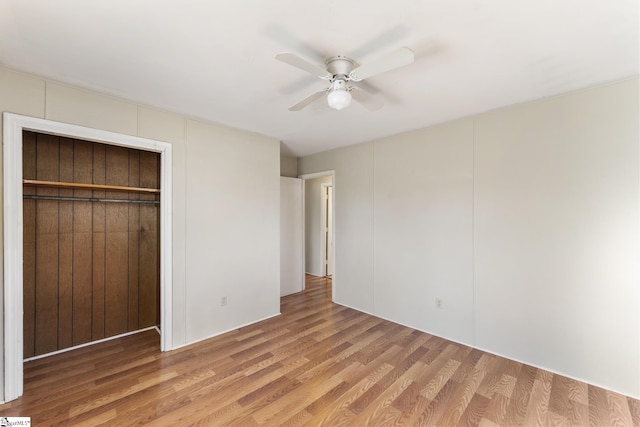 unfurnished bedroom with a closet, ceiling fan, and light hardwood / wood-style floors