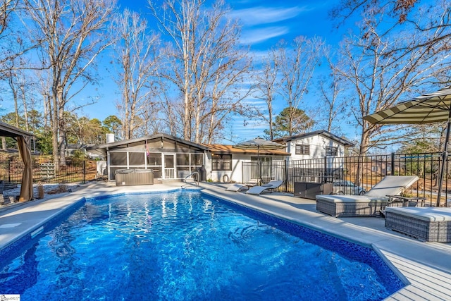 view of pool with a patio and a sunroom