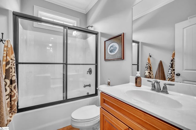 full bathroom with vanity, toilet, ornamental molding, and enclosed tub / shower combo