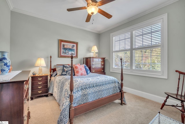 carpeted bedroom with ceiling fan and ornamental molding