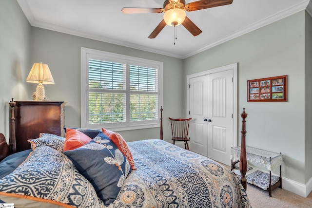 bedroom featuring carpet flooring, ceiling fan, ornamental molding, and a closet