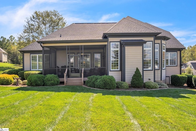 back of house featuring a sunroom and a yard