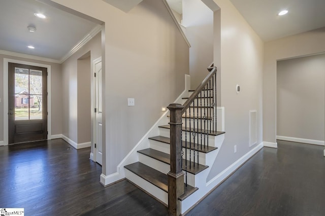 entrance foyer featuring dark hardwood / wood-style flooring and crown molding