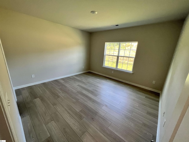 unfurnished room with light hardwood / wood-style flooring