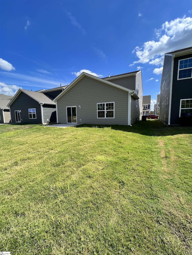 rear view of property with a lawn