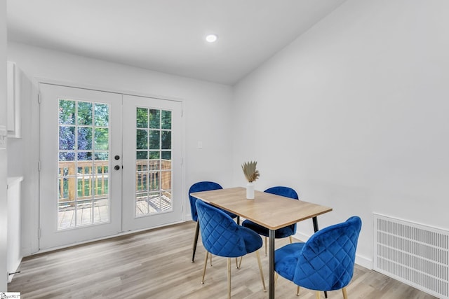 dining room featuring french doors and light wood-type flooring