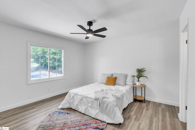 bedroom featuring light hardwood / wood-style flooring and ceiling fan