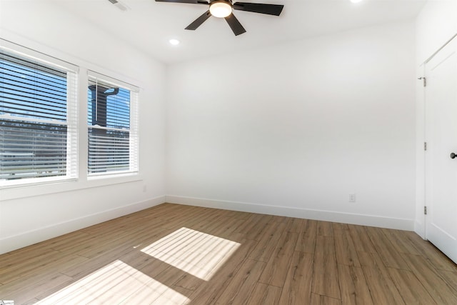 empty room featuring ceiling fan and light hardwood / wood-style floors