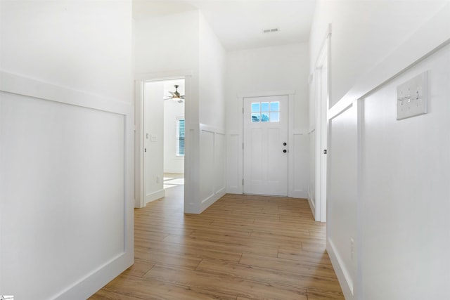 corridor with light hardwood / wood-style flooring