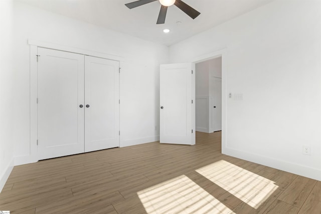 unfurnished bedroom featuring light wood-type flooring, a closet, and ceiling fan