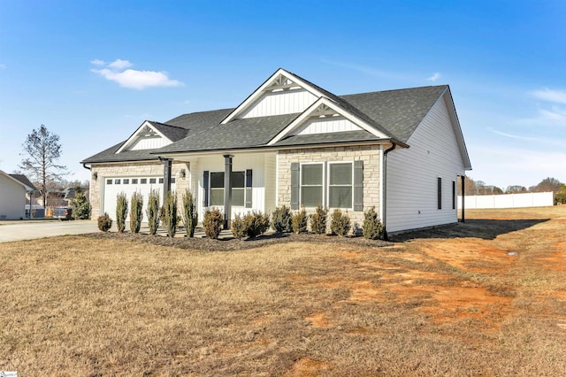 craftsman-style home featuring a front lawn and a garage