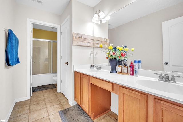 full bathroom featuring vanity, toilet, and combined bath / shower with glass door