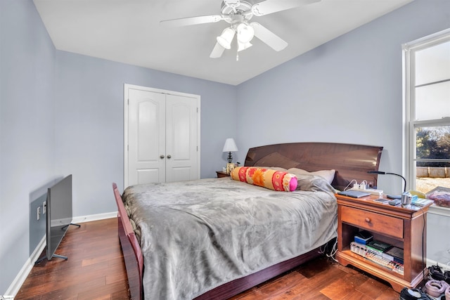 bedroom featuring ceiling fan, dark hardwood / wood-style flooring, and a closet