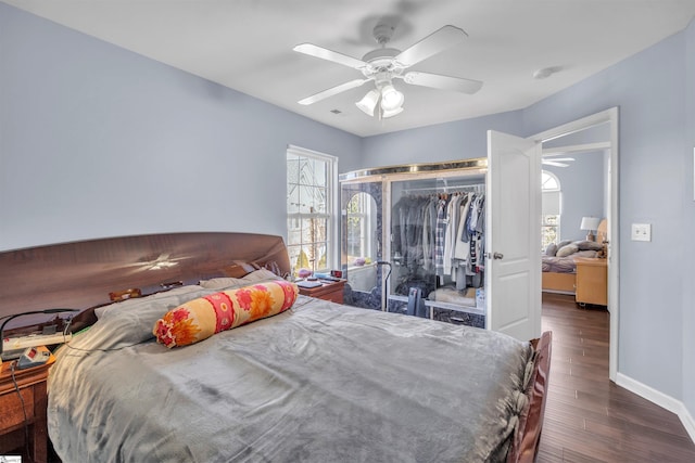 bedroom featuring ceiling fan, dark wood-type flooring, and a closet