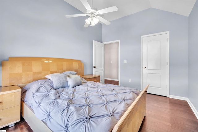 bedroom with ceiling fan, dark wood-type flooring, and lofted ceiling