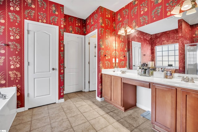 bathroom featuring tile patterned flooring, vanity, and a tub