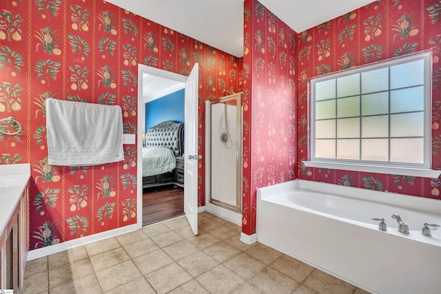 bathroom featuring tile patterned flooring, vanity, and shower with separate bathtub