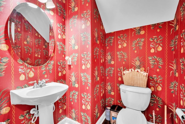 bathroom featuring hardwood / wood-style floors and toilet