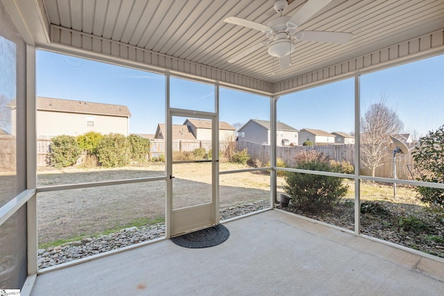 unfurnished sunroom featuring ceiling fan