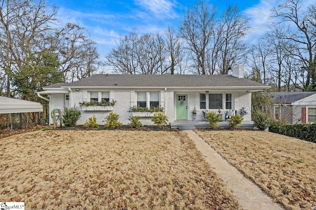 ranch-style home featuring a porch, a front lawn, and a carport