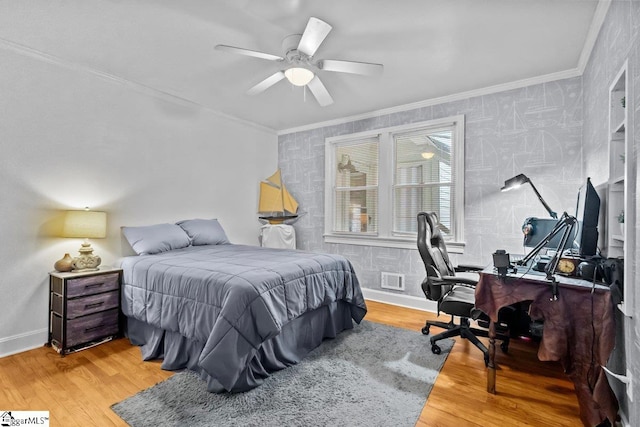 bedroom featuring ceiling fan, light wood-type flooring, and crown molding