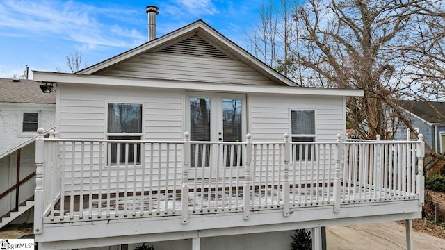 back of house featuring french doors and a wooden deck