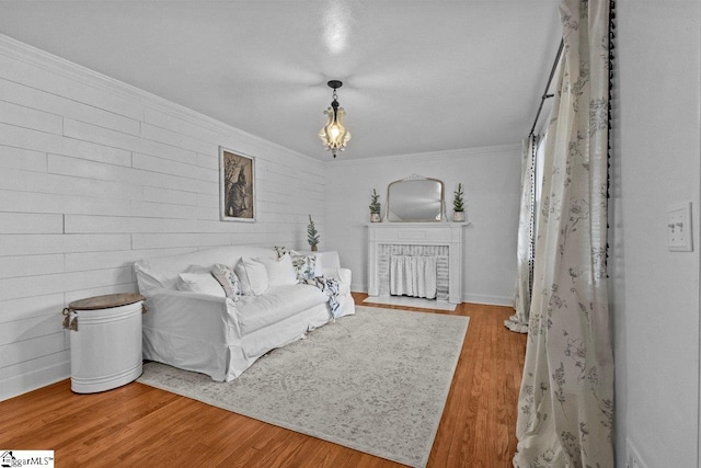 living room with crown molding and light hardwood / wood-style flooring