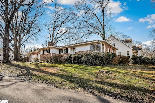 single story home featuring a front yard and a garage