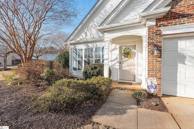 view of exterior entry with a garage