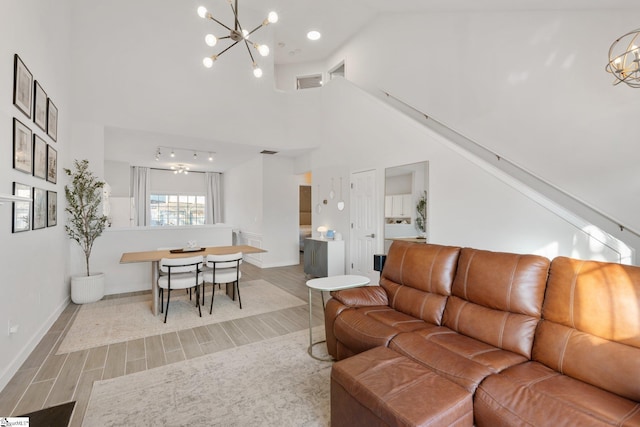 living room featuring a high ceiling and an inviting chandelier