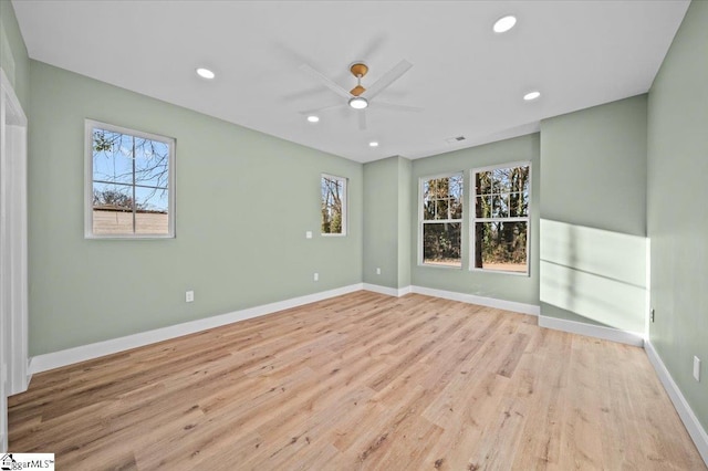 spare room featuring ceiling fan and light wood-type flooring