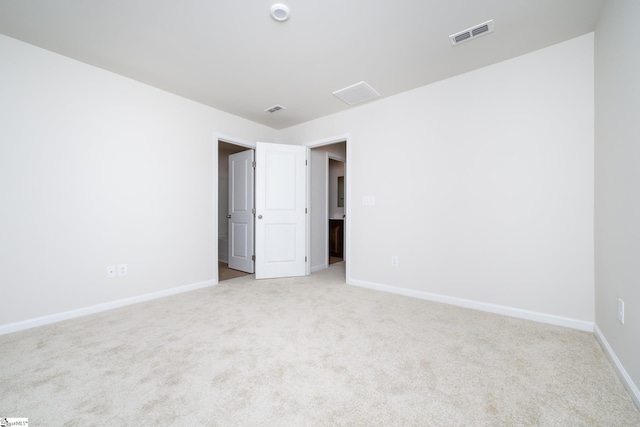 empty room featuring light colored carpet