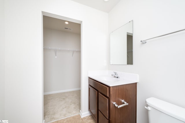 bathroom with toilet and vanity