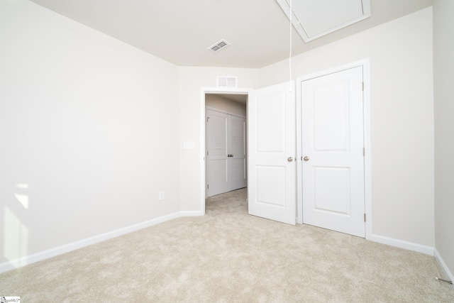 unfurnished bedroom with light colored carpet