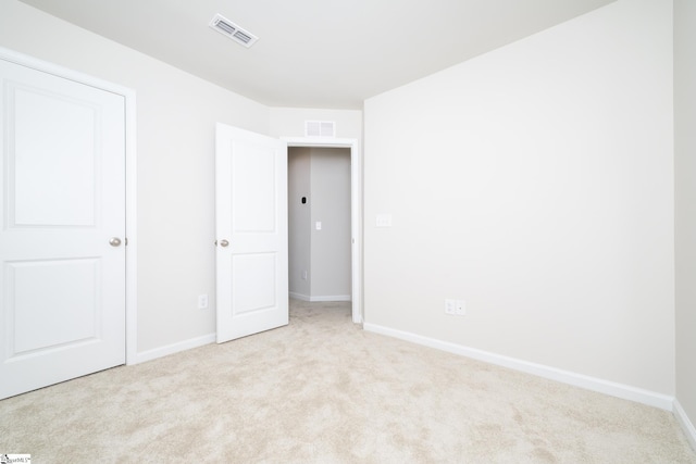 unfurnished bedroom with light colored carpet