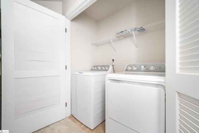 clothes washing area with washer and clothes dryer