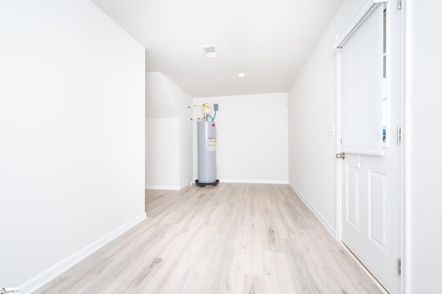 interior space featuring electric water heater and light hardwood / wood-style flooring