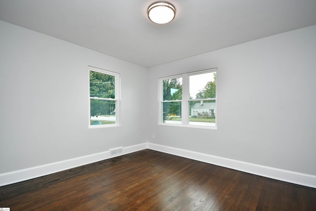 empty room featuring dark wood-type flooring