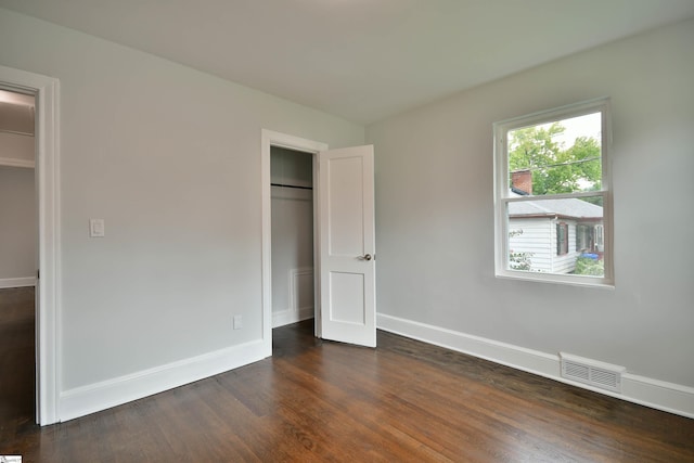 unfurnished bedroom featuring dark hardwood / wood-style floors