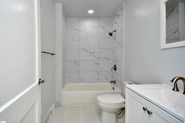 full bathroom with tile patterned flooring, tiled shower / bath combo, vanity, and toilet